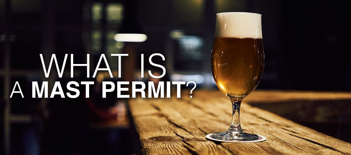 What is a MAST Permit? A dark beer on a rustic old bartop.