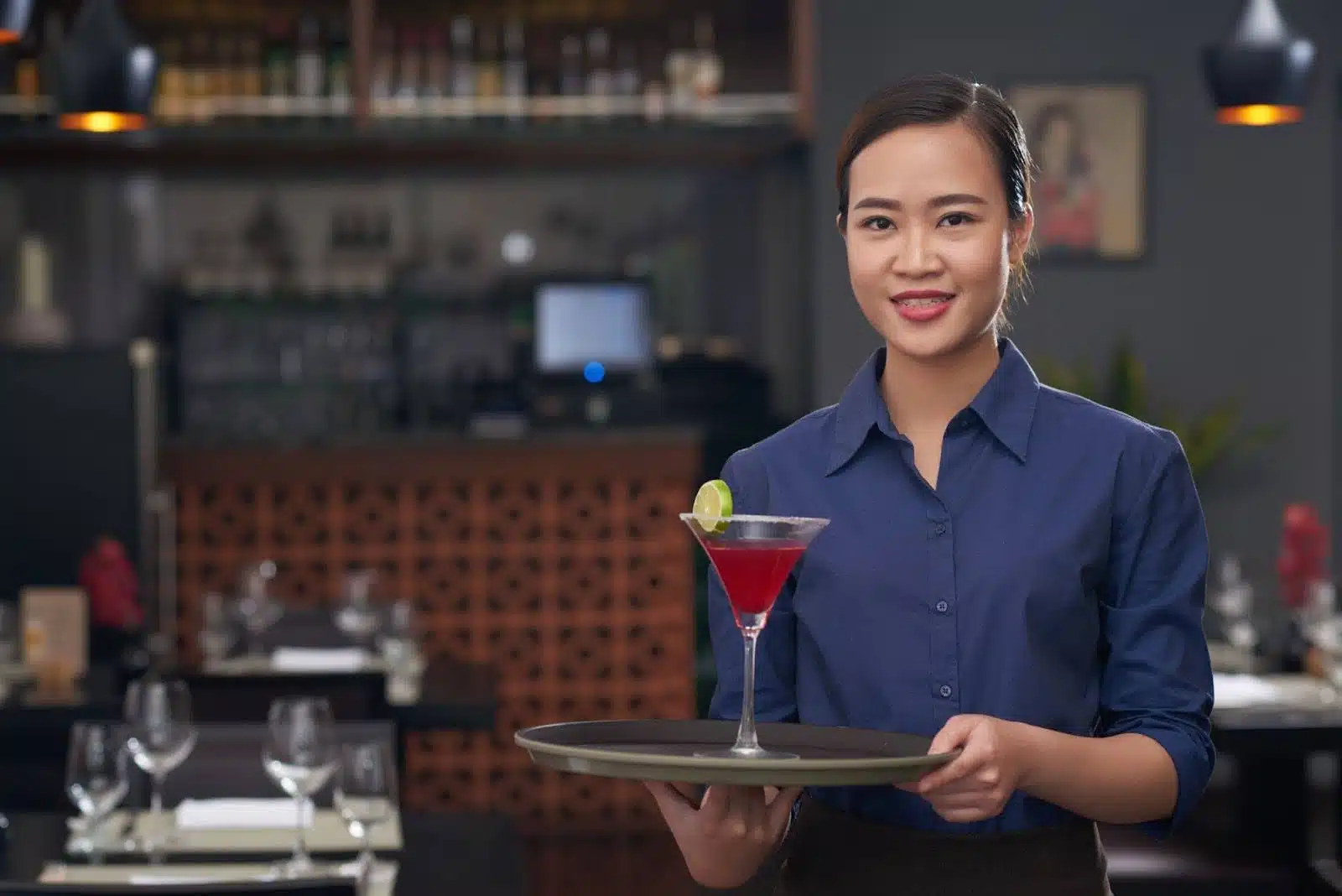 Young Class 13 MAST permit holder serving drinks at a Washington restaurant