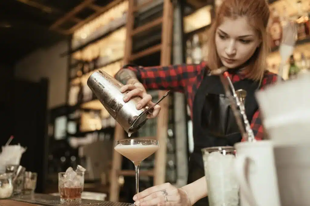 a bartender pouring cocktail