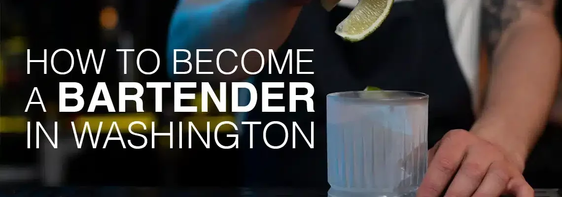 How to become a bartender in Washington. Man dropping lime into cocktail glass.